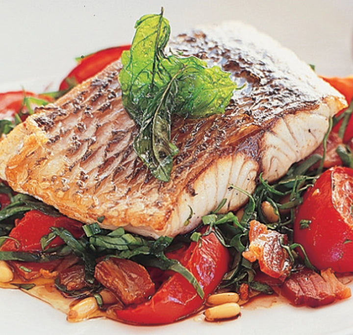 Roast baby tomatoes and spinach salad with barramundi fillet